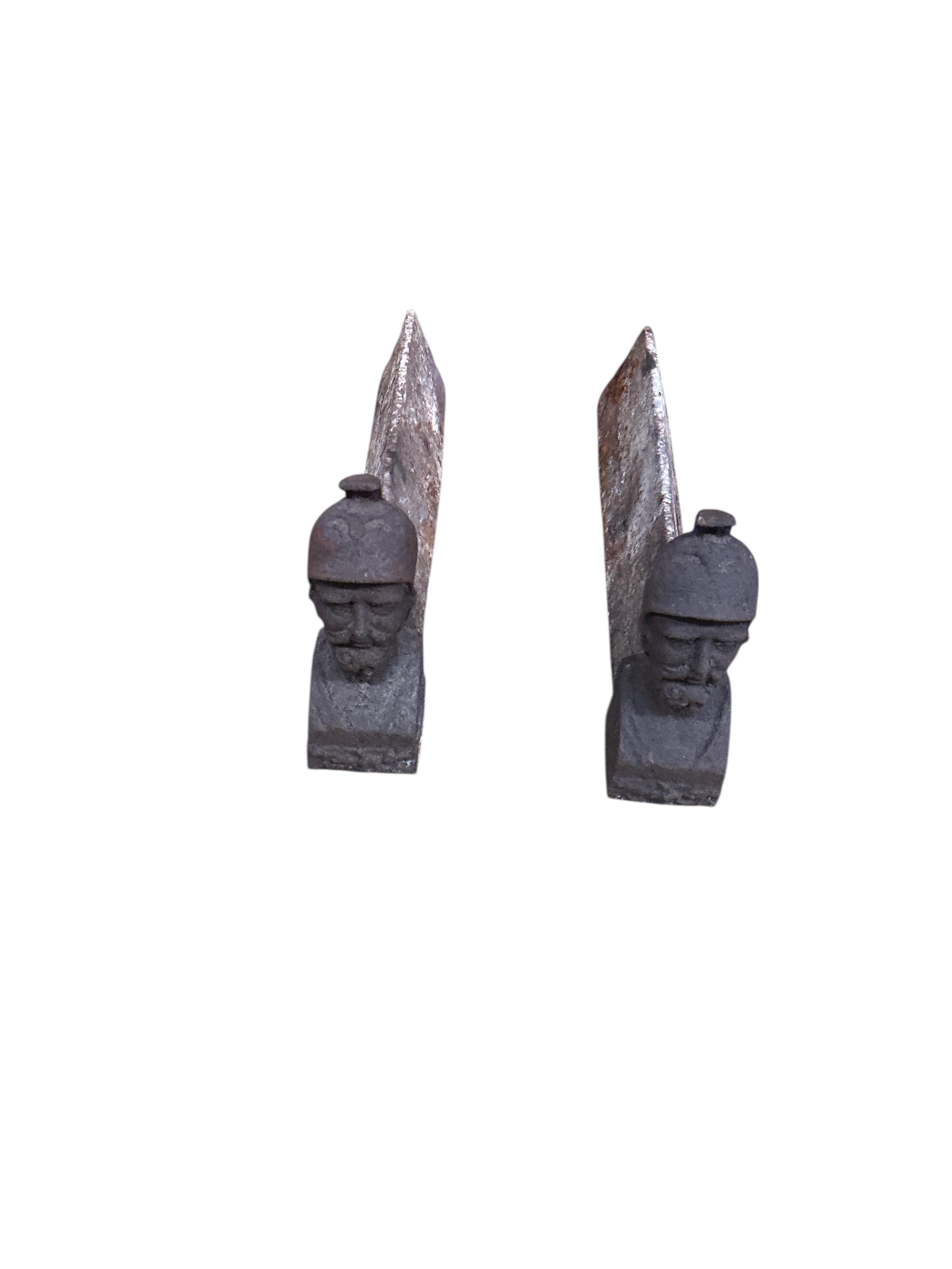 Three pairs of Victorian cast iron fire dogs and a fireback, damaged